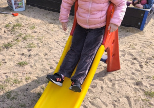 Dziewczynka zjeżdża ze zjeżdżalni